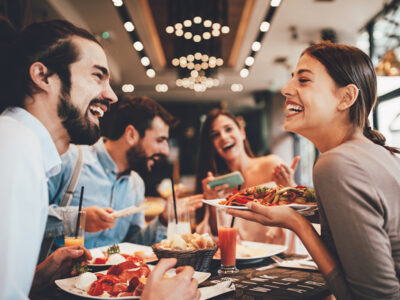 Group of Happy friends having breakfast in the restaurant